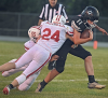 Random Lake/Ozaukee’s Colton Dybul fought for extra yards with Valders’ Brody Mueller (24) and Kale Zimmermann (55) hanging on him in RLO’s 49-14 home loss on Aug. 29.