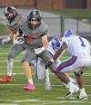 Grafton’s Jack Nelson evaded a tackler as Colton Boehlke (87) looked to block someone during Grafton’s 35-13 win over Wisconsin Lutheran in Grafton on Sept. 11.