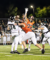 Grafton High School’s Colton Boehlke pressured the quarterback while Max Glab tried to deflect a pass in the Black Hawks’ 66-33 homecoming win over Greenfield on Sept. 26.